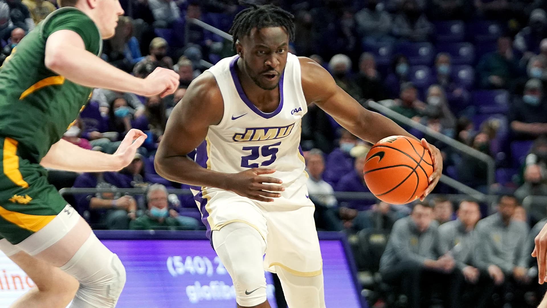 Axis mentor Alonzo Sule dribbling for James Madison University against William & Mary