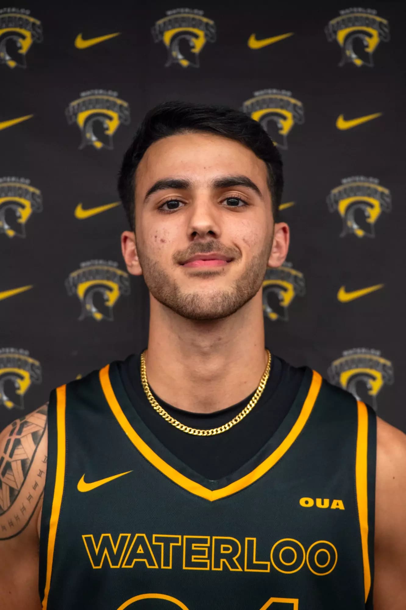 Arshya Ghasemi in a black Waterloo basketball jersey.