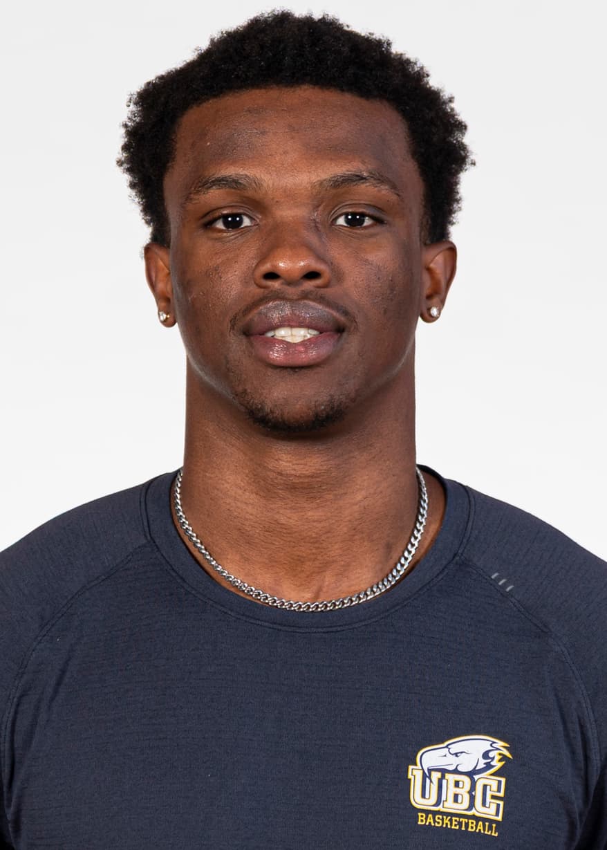 Immanuel Oludele wearing a navy UBC Basketball shirt against a light background