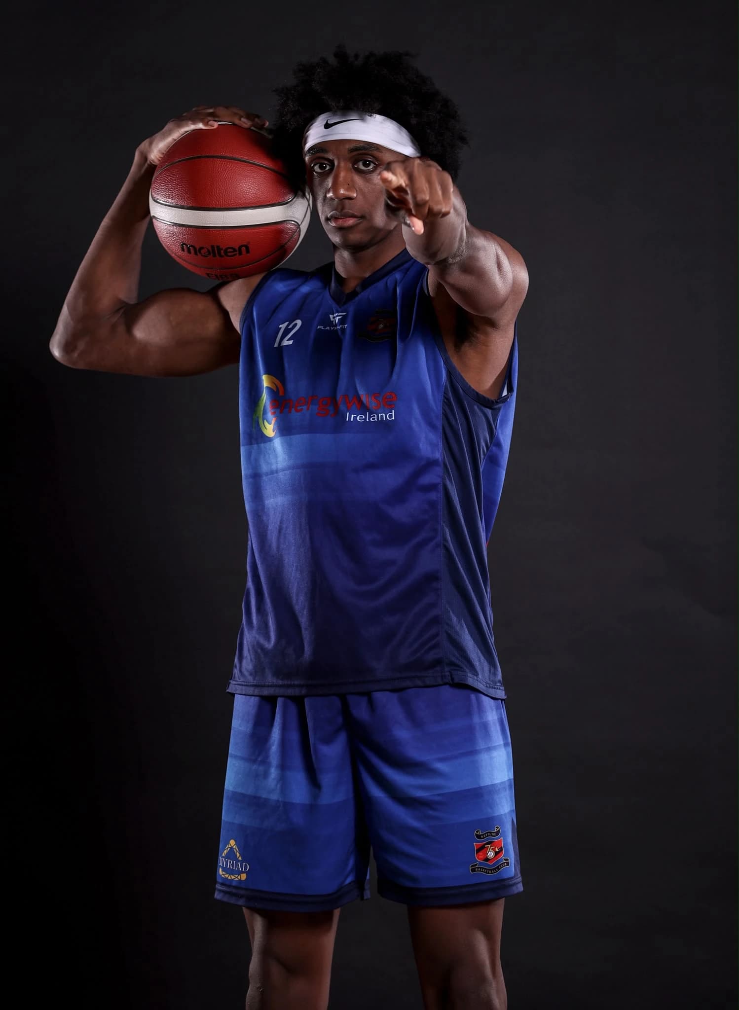 Jahmal Wright holding a basketball in his blue Neptune Basketball Club uniform.