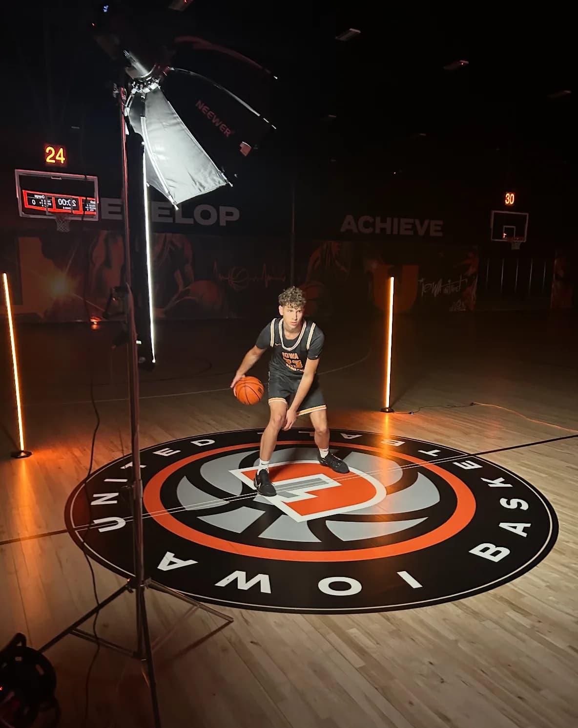 Logan holding a basketball on the Iowa United court